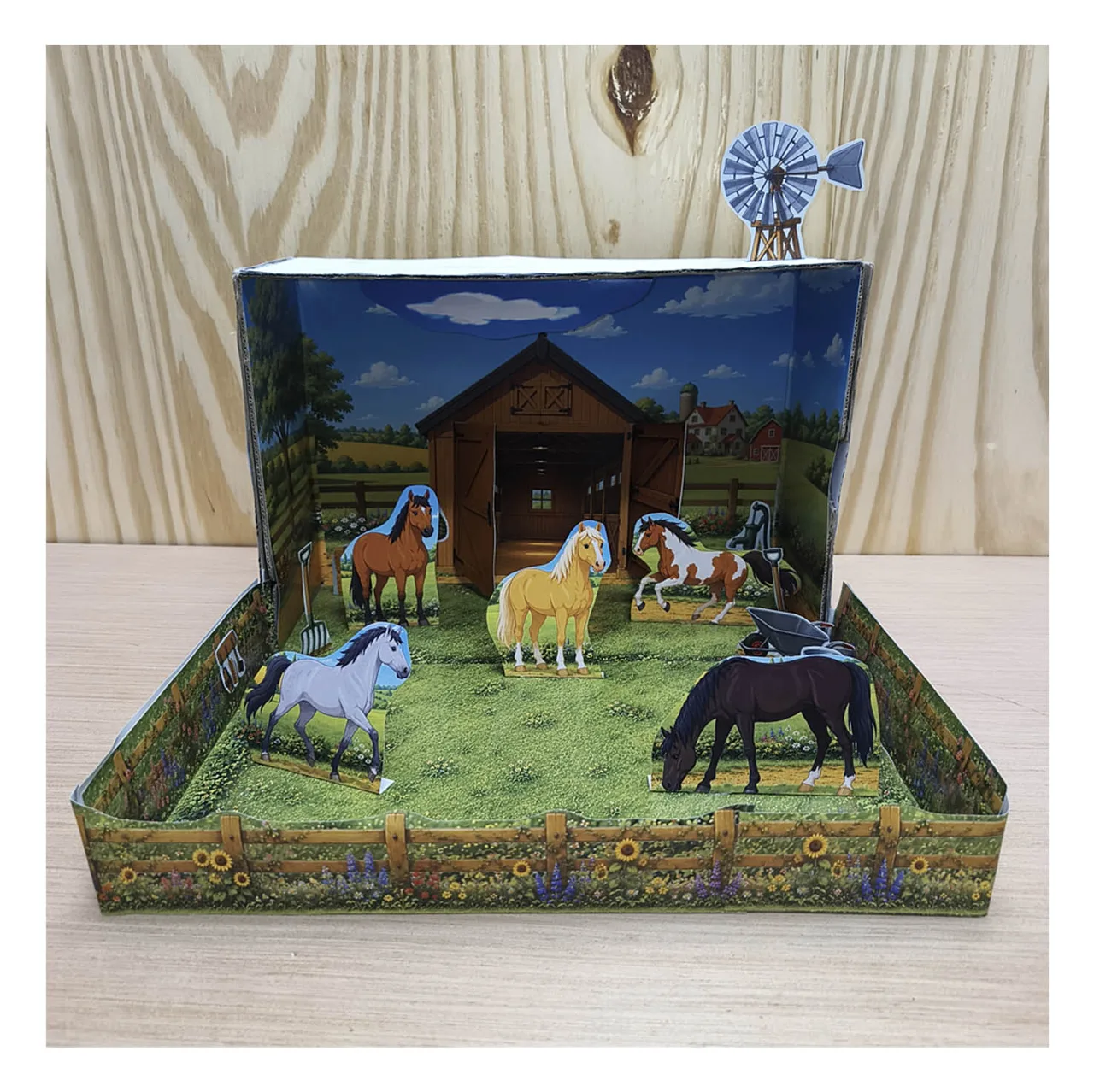 Printable horse stable and paddock shoebox diorama with five paper horses, wooden fences, flowers and a country windmill