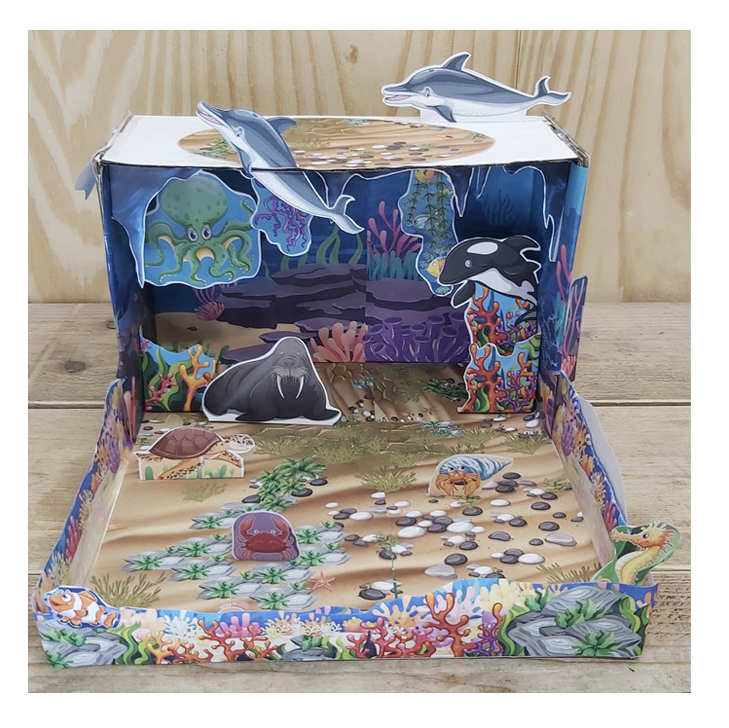 Completed ocean habitat diorama school project with sea animals, coral and underwater scenery