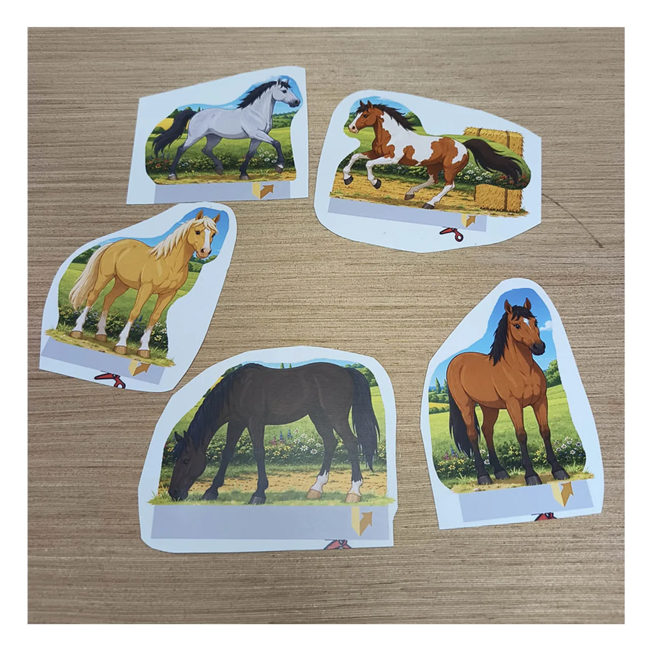 Five colorful printable paper horses cut out and ready to add to the horse stable and paddock diorama