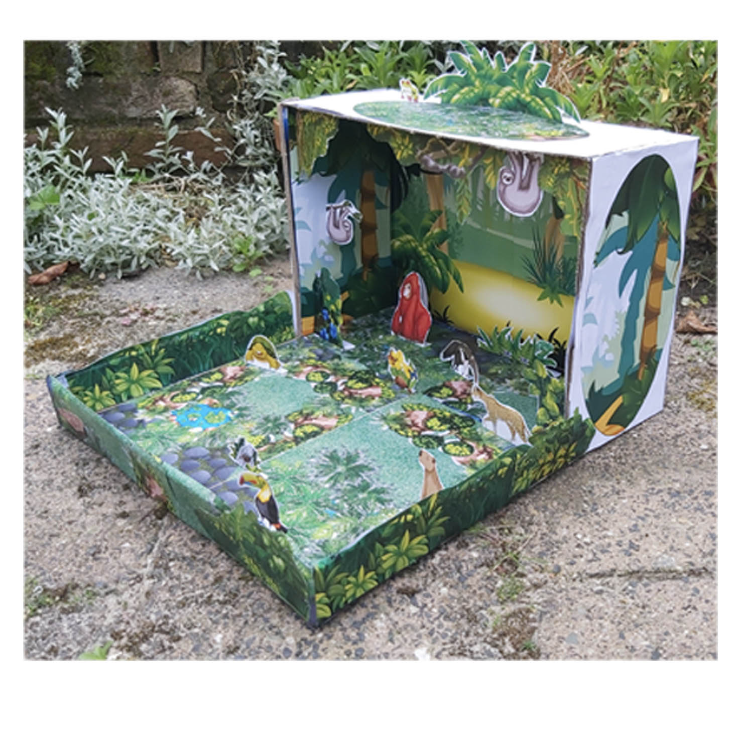 Completed rainforest habitat diorama with toucan, orangutan, sloths, anteater and other animals arranged in tropical scenery