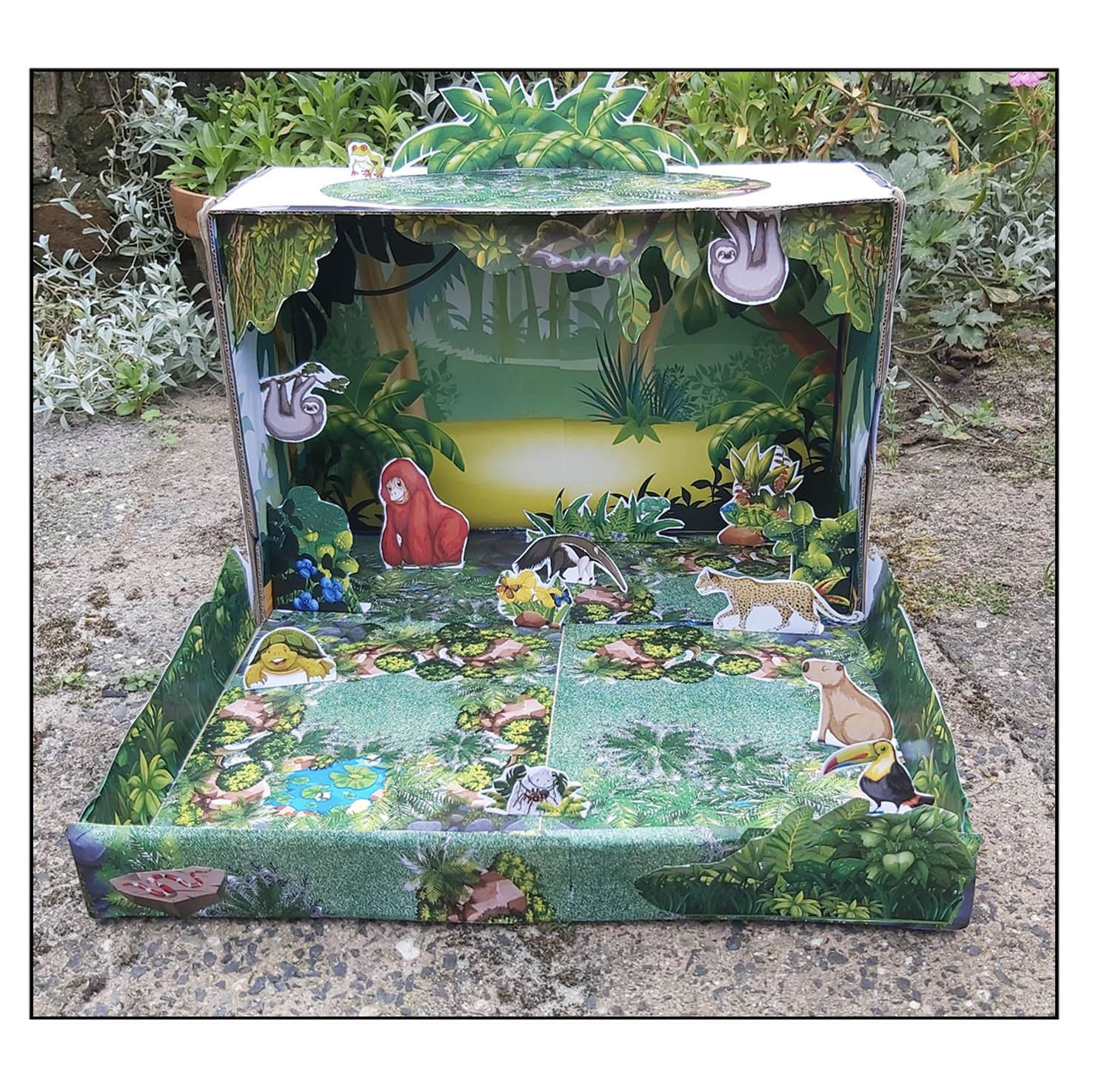 Completed rainforest habitat diorama with tropical forest scenery, orangutan, sloths, toucan, anteater and other rainforest animals