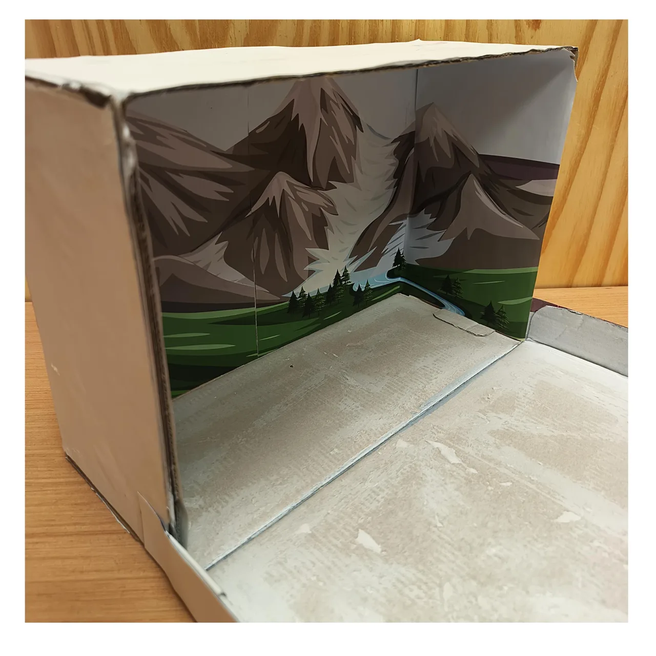 Printed mountain landscape attached to the back and sides of the shoebox
