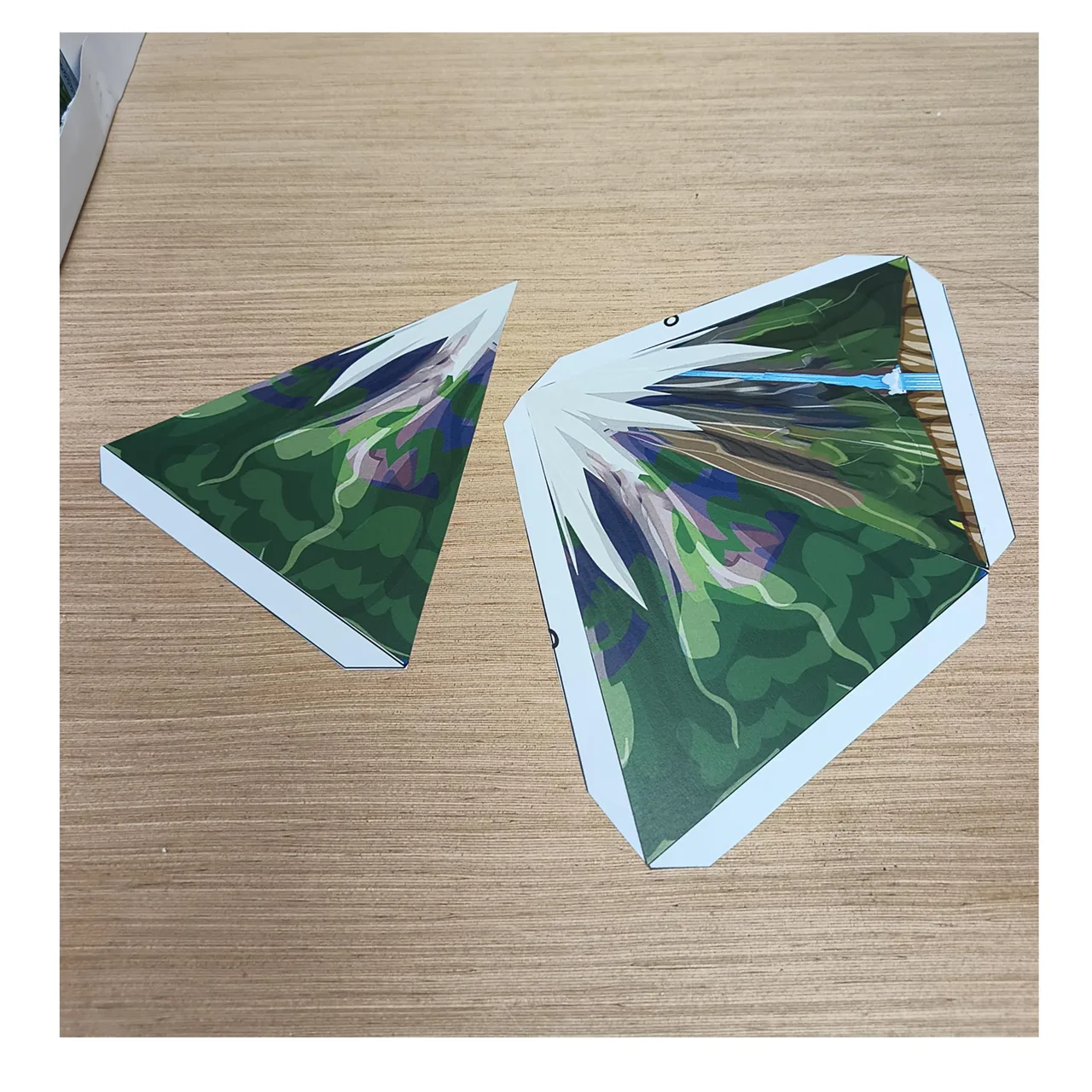 Flat paper mountain pieces with white glue tabs